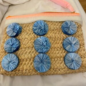 NWT and in plastic Milly brand straw Pom Pom clutch style purse